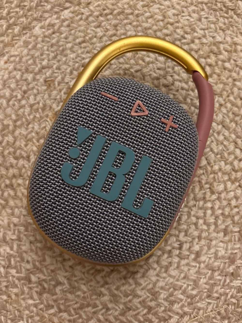 JBL Portable Bluetooth Speaker in Gray with Teal Logo and Gold Carabiner.